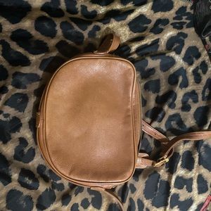 MCM crossbody bag cognac color with normal wear.  Minor discoloration on flat.